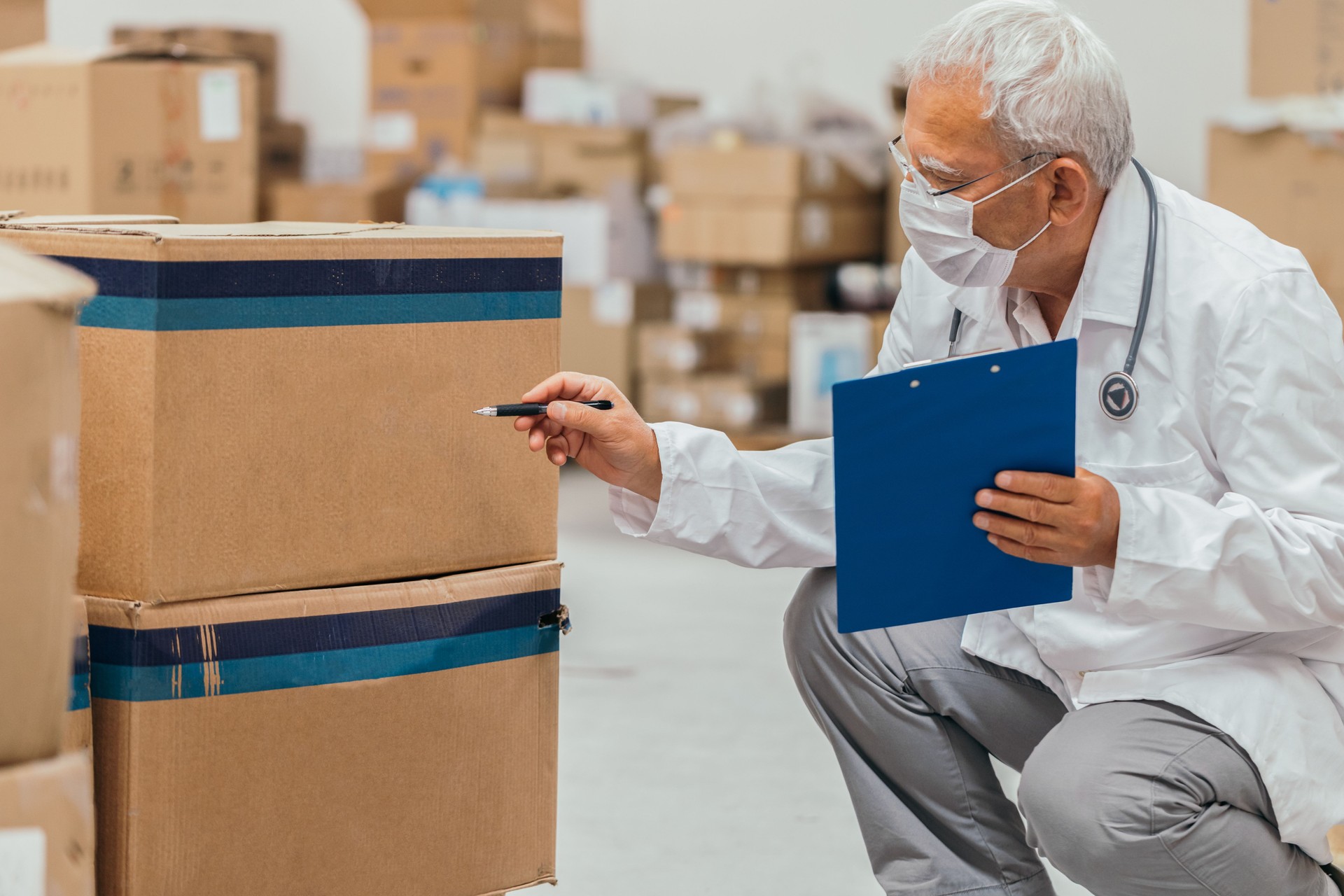 Senior doctor checking medical stock in a warehouse